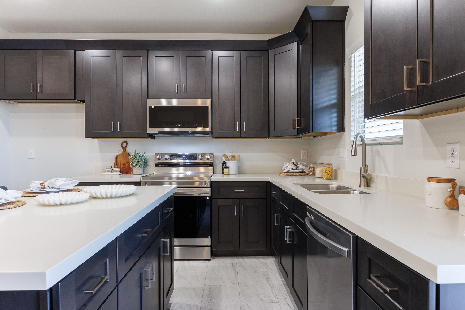 Kitchen with dark cabinetry and a white island at 11119 W Hobbit Drive
